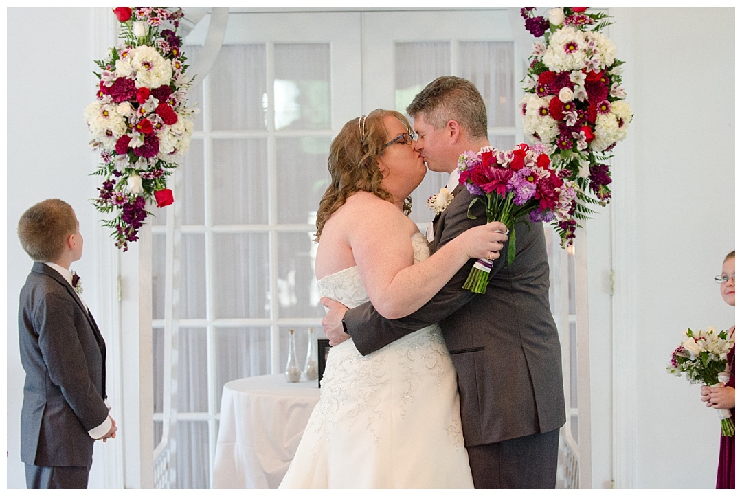 bride and groom first kiss