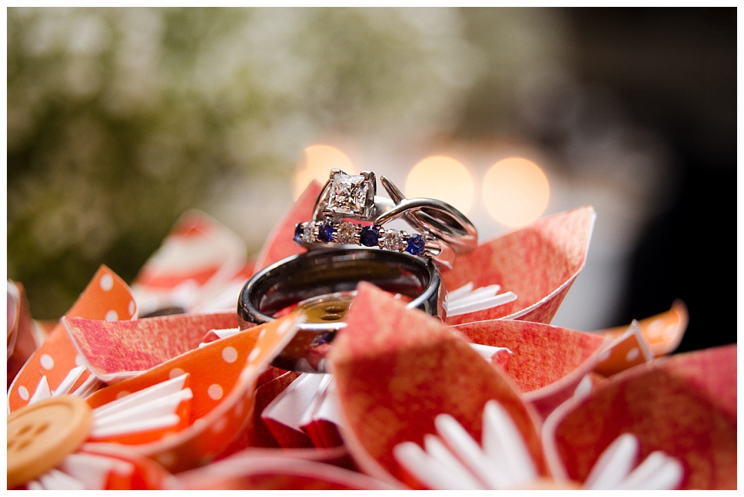 wedding rings on paper flowers